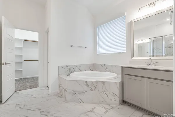 a bathroom with a shower and a sink