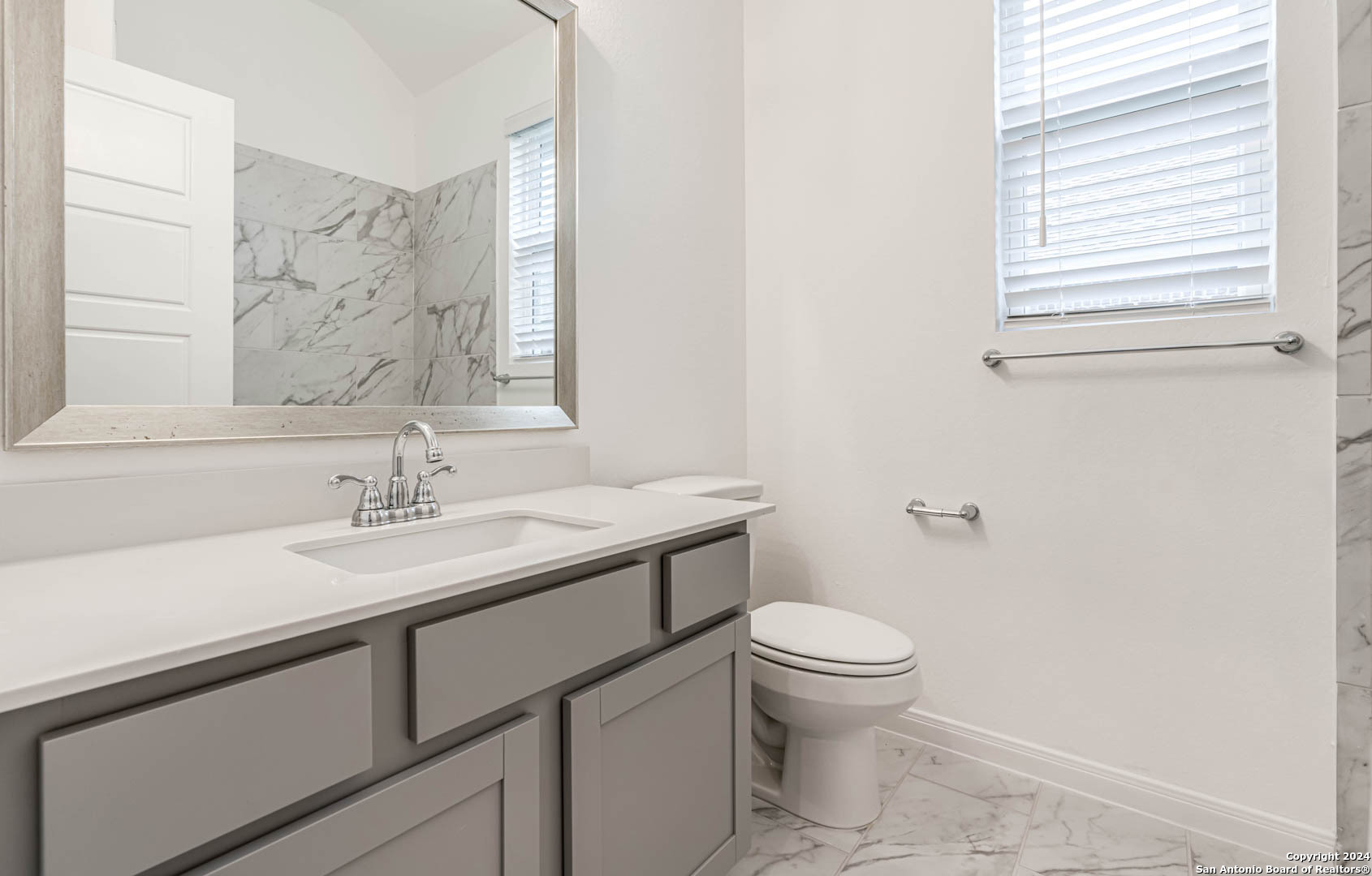 113 Valencia Boerne, TX 78006 - Photo 30 of 43 a bathroom with a sink a toilet and a mirror