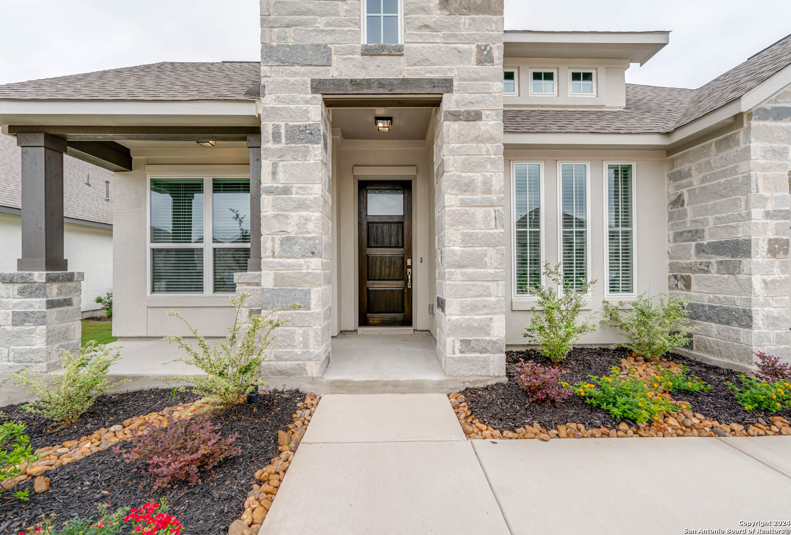 113 Valencia Boerne, TX 78006 - Photo 3 of 43 a front view of a brick house with potted plants