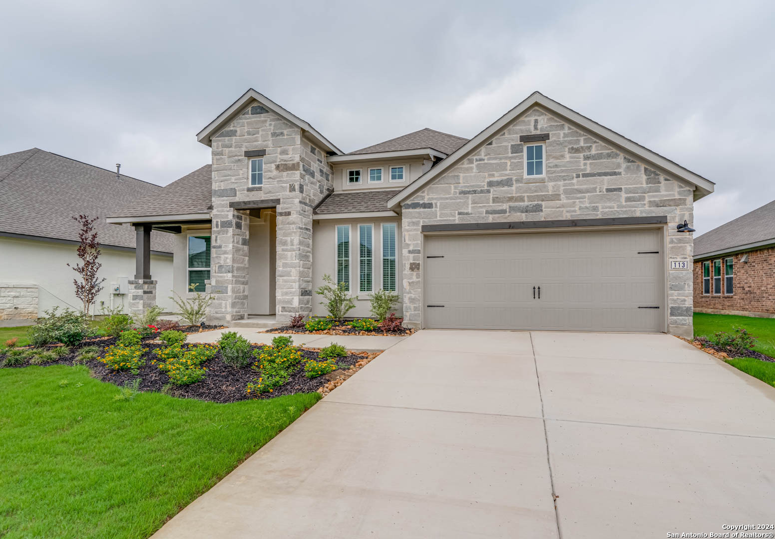113 Valencia Boerne, TX 78006 - Photo 43 of 43 a front view of a house with a garden and garage