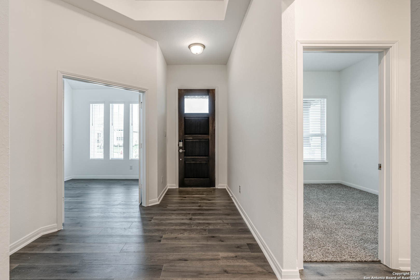 113 Valencia Boerne, TX 78006 - Photo 5 of 43 a view of a hallway with wooden floor and staircase