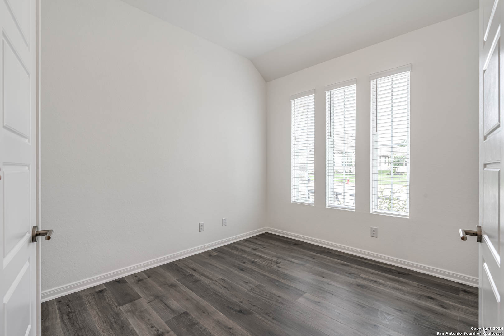 113 Valencia Boerne, TX 78006 - Photo 7 of 43 an empty room with wooden floor and windows
