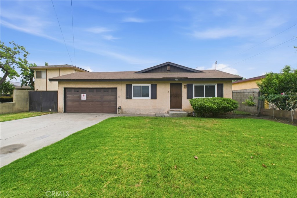 456 West Bennett Street Compton, CA 90220 - Photo 1 of 13 a front view of a house with a garden and yard
