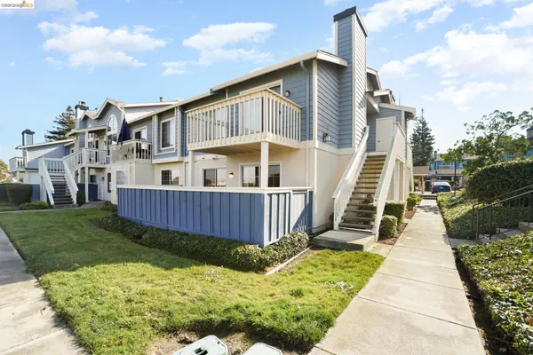 a view of a house with wooden fence