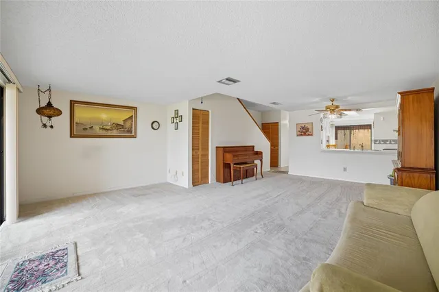 a view of a livingroom with furniture and staircase