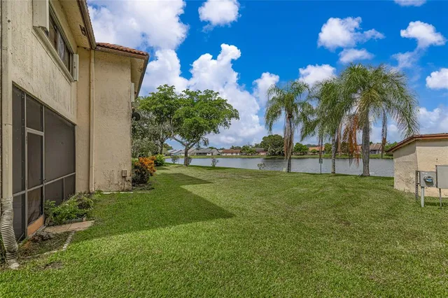 a view of a house with a backyard