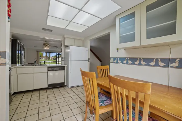 a kitchen with a sink a refrigerator and cabinets