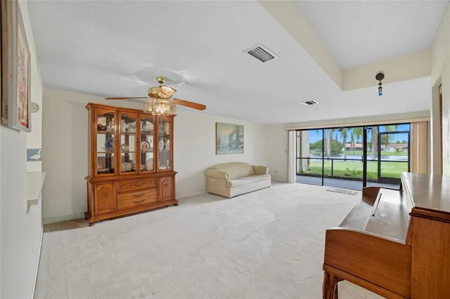 a bedroom with furniture and large windows