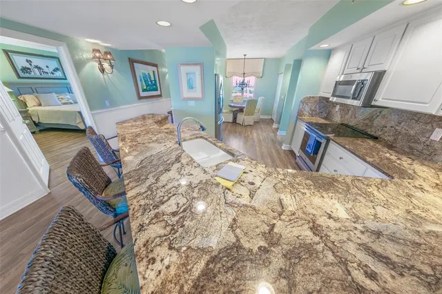 a bathroom with a double vanity sink a toilet a mirror and shower