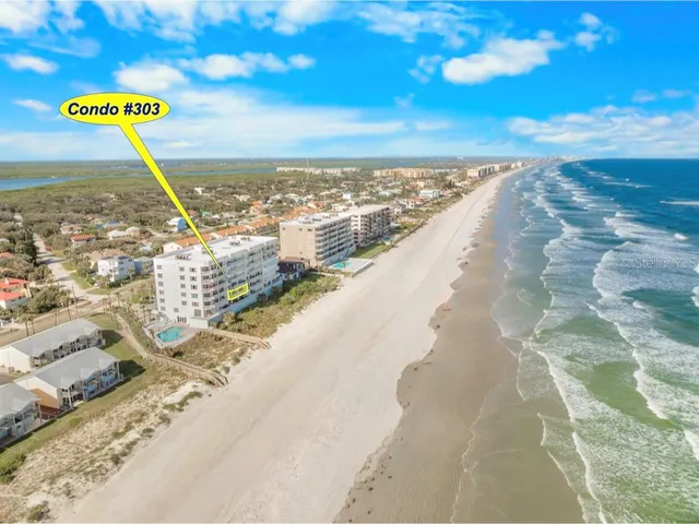 a view of a kitchen with fridge and wooden floor