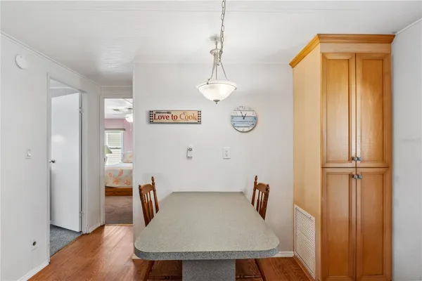 a dining room with furniture a chandelier and wooden floor