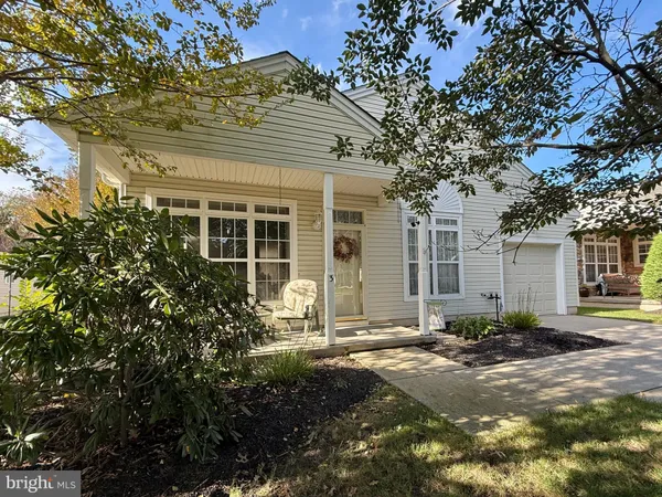 front view of a house with a tree