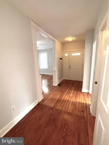 a view of a room with wooden floor and a window