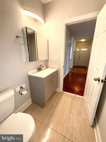 a bathroom with a sink mirror vanity and toilet