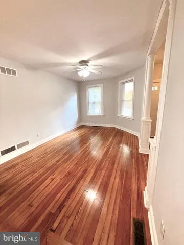 wooden floor in an empty room with a window