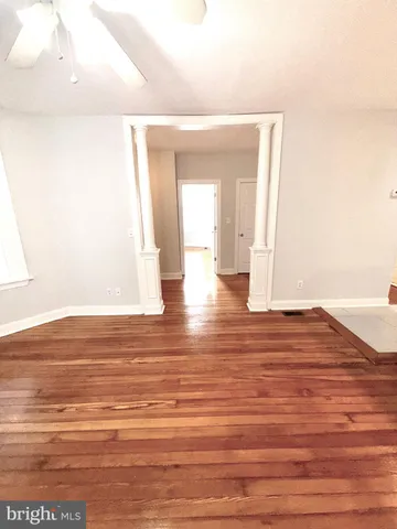 a view of a room with wooden floor
