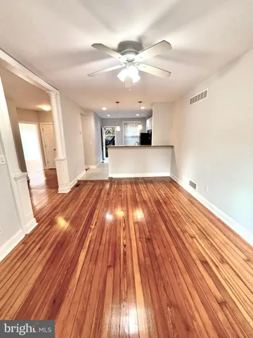 a view of a living room with wooden floor