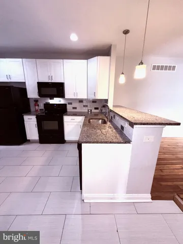 a kitchen with a sink a counter top space and appliances