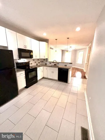 a large white kitchen with a large window