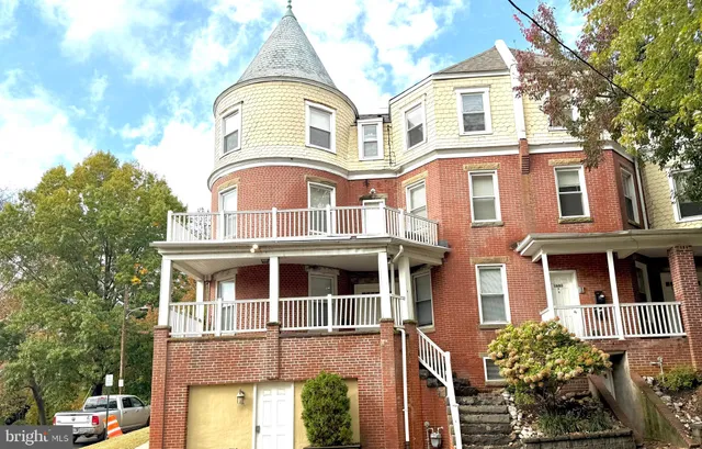 a front view of a residential apartment building with a yard