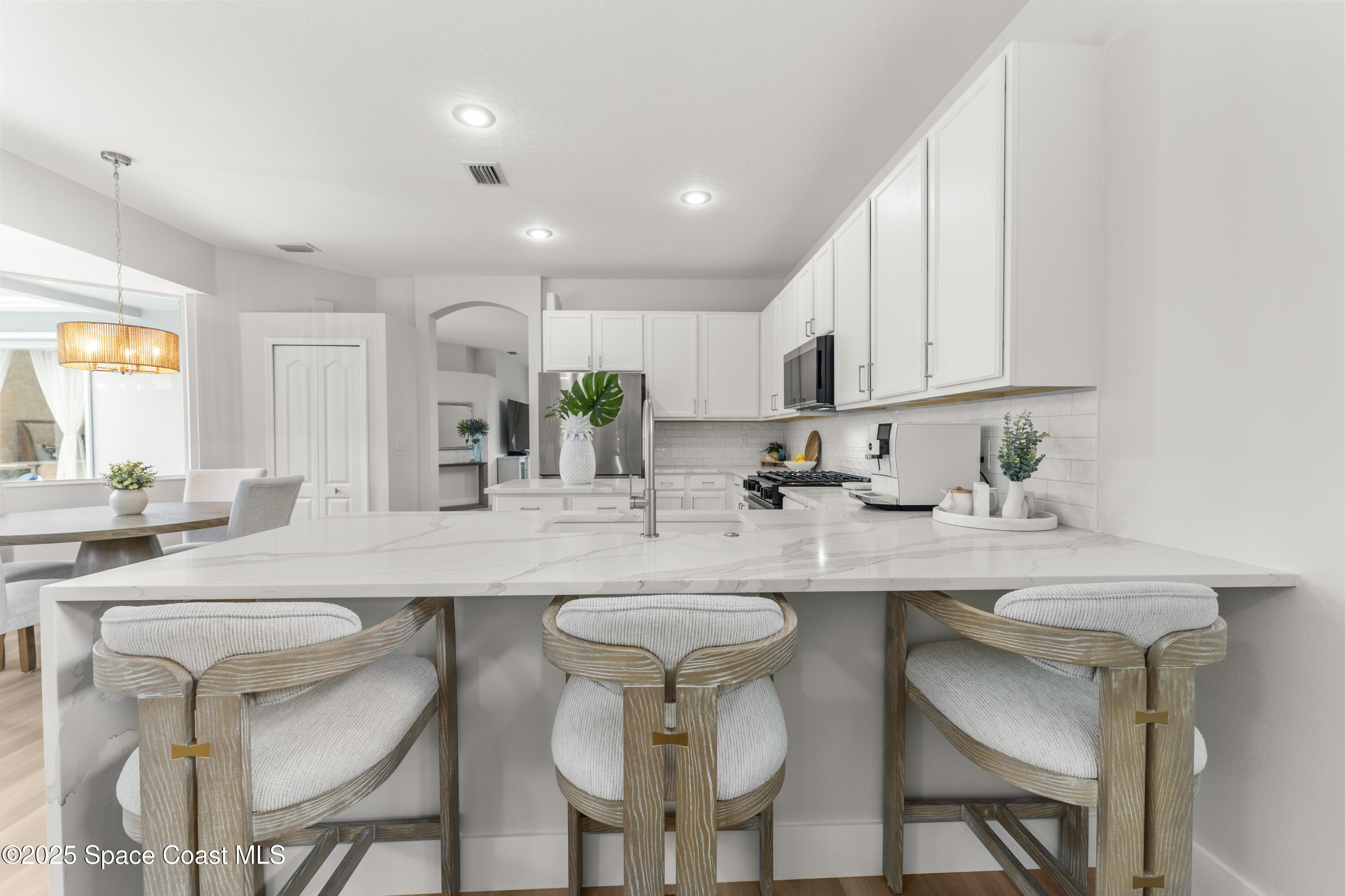 3053 Jacobaeus Lane Indialantic, FL 32903 - Photo 12 of 35 a kitchen with stainless steel appliances a sink and cabinets