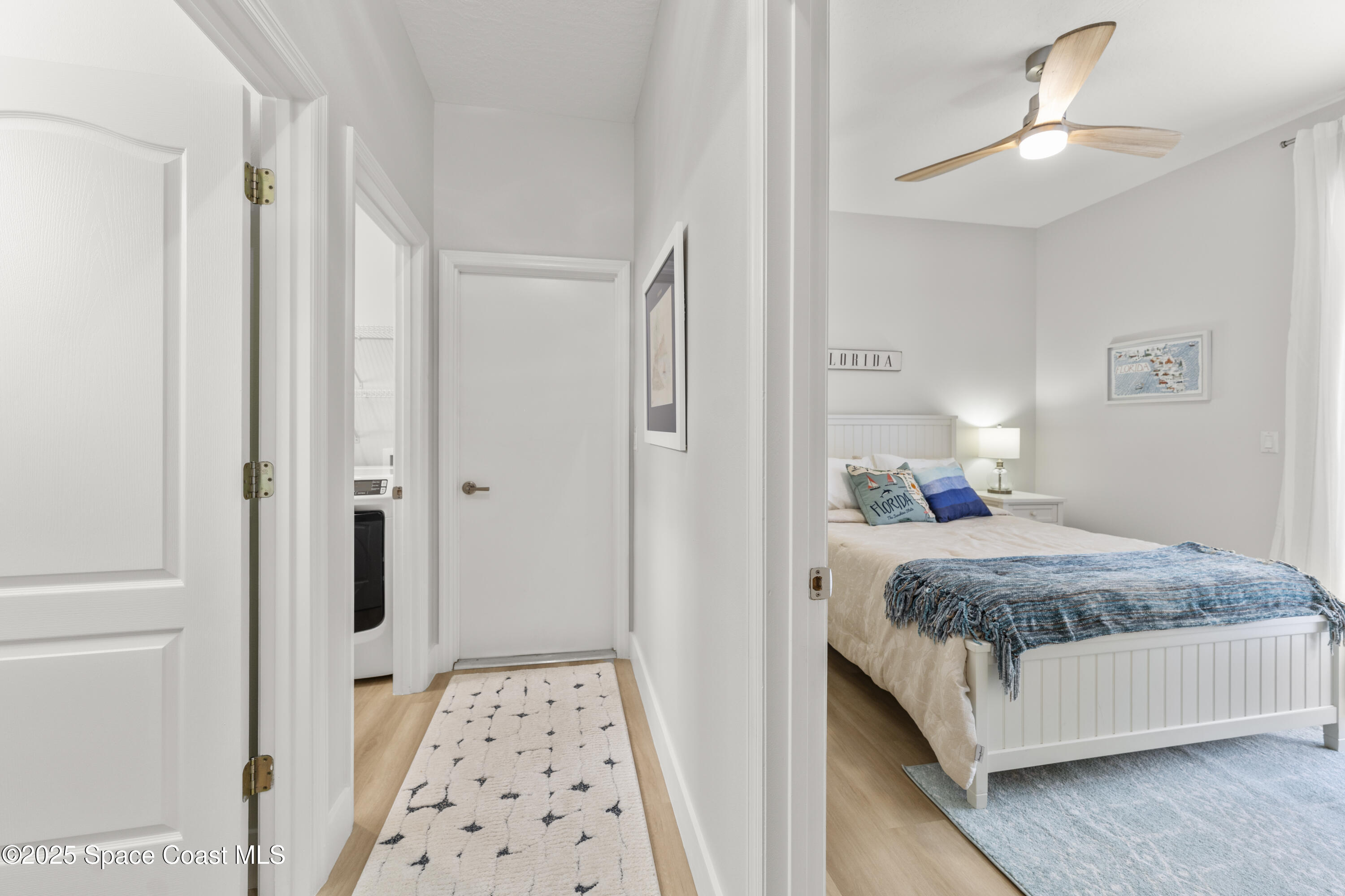 3053 Jacobaeus Lane Indialantic, FL 32903 - Photo 15 of 35 a bedroom with a bed and a chandelier