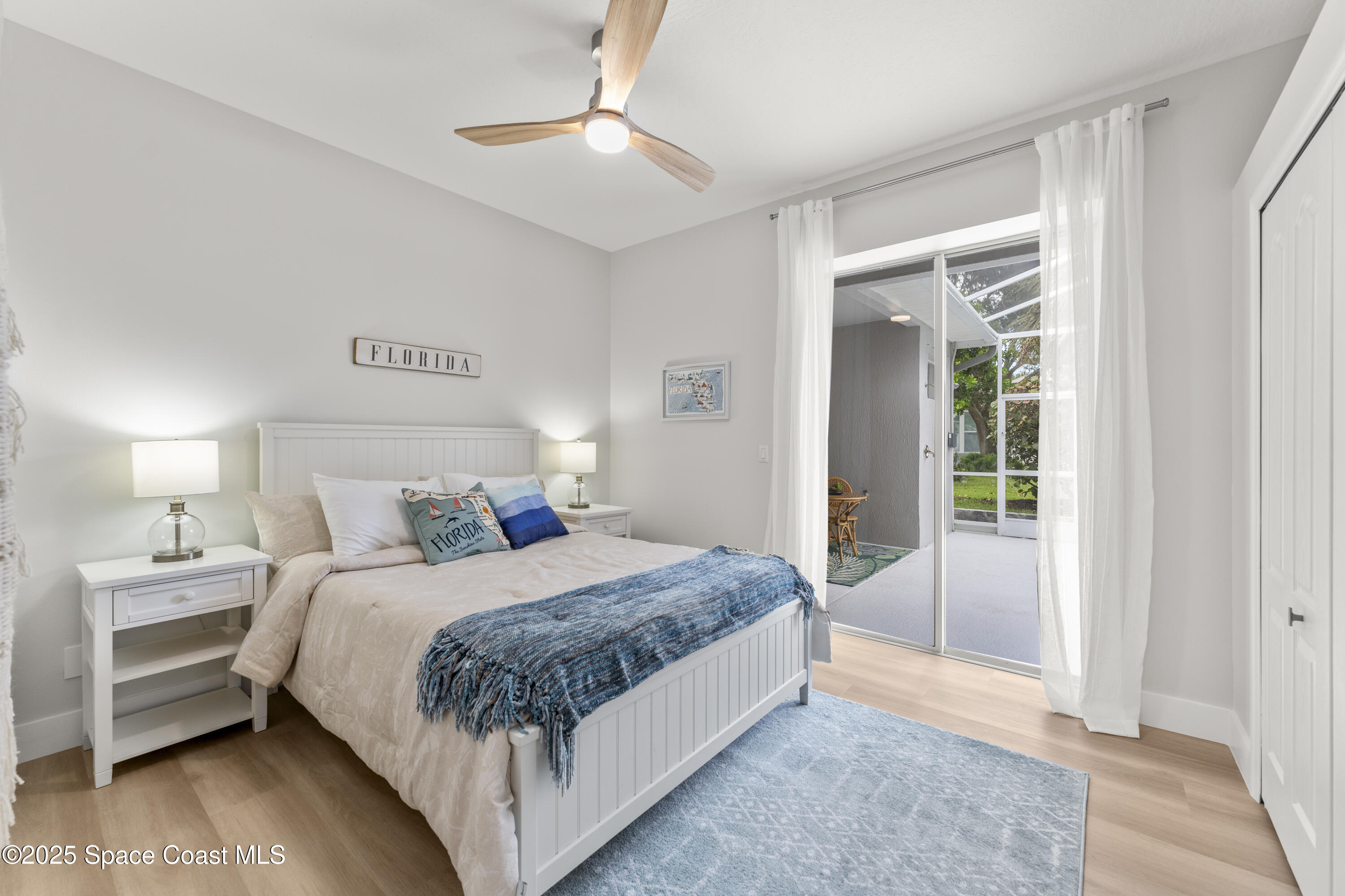 3053 Jacobaeus Lane Indialantic, FL 32903 - Photo 16 of 35 a bedroom with a bed and a chandelier