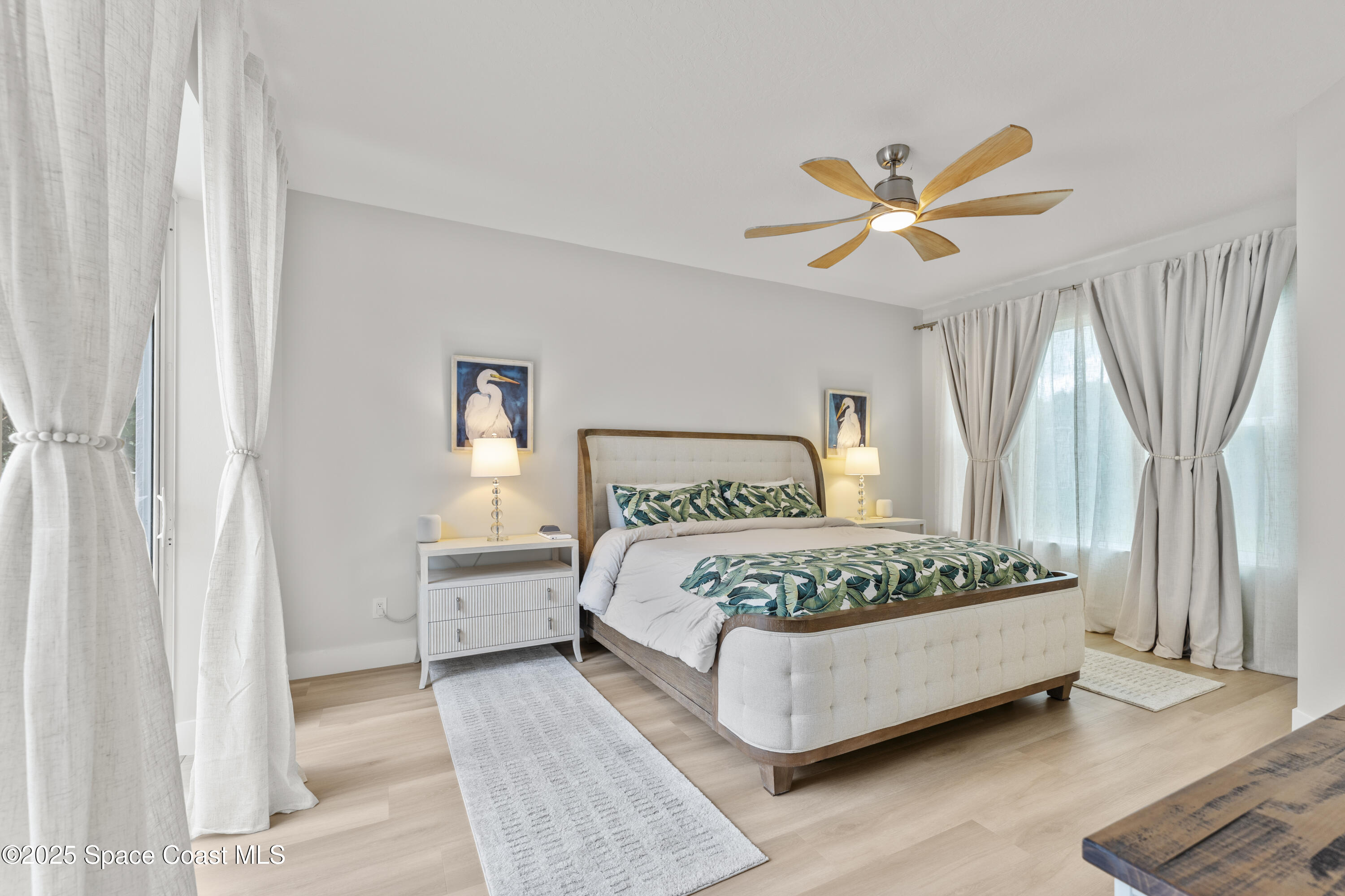 3053 Jacobaeus Lane Indialantic, FL 32903 - Photo 19 of 35 a bedroom with a bed chandelier and a window