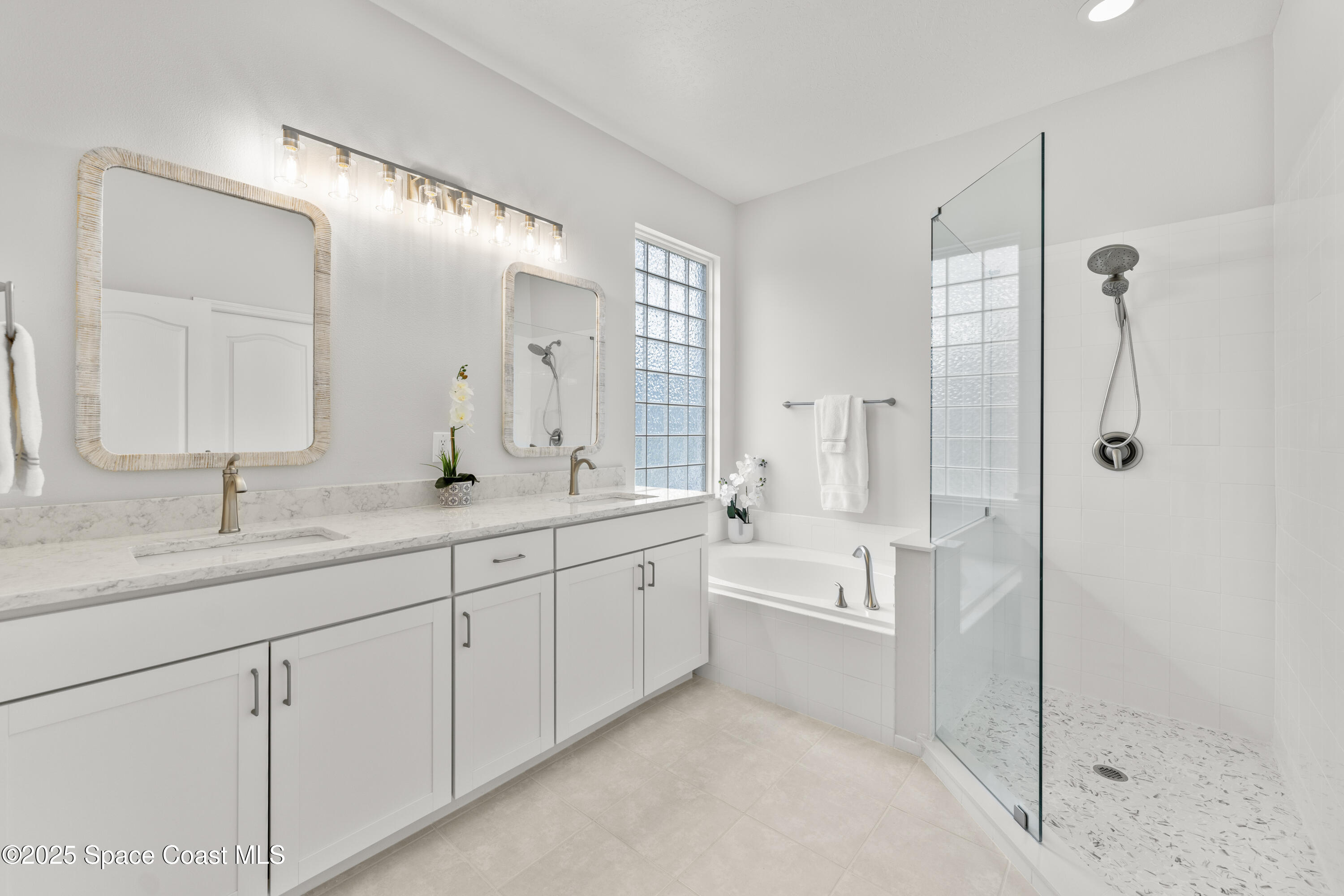 3053 Jacobaeus Lane Indialantic, FL 32903 - Photo 21 of 35 a spacious bathroom with a double vanity sink mirror double and shower