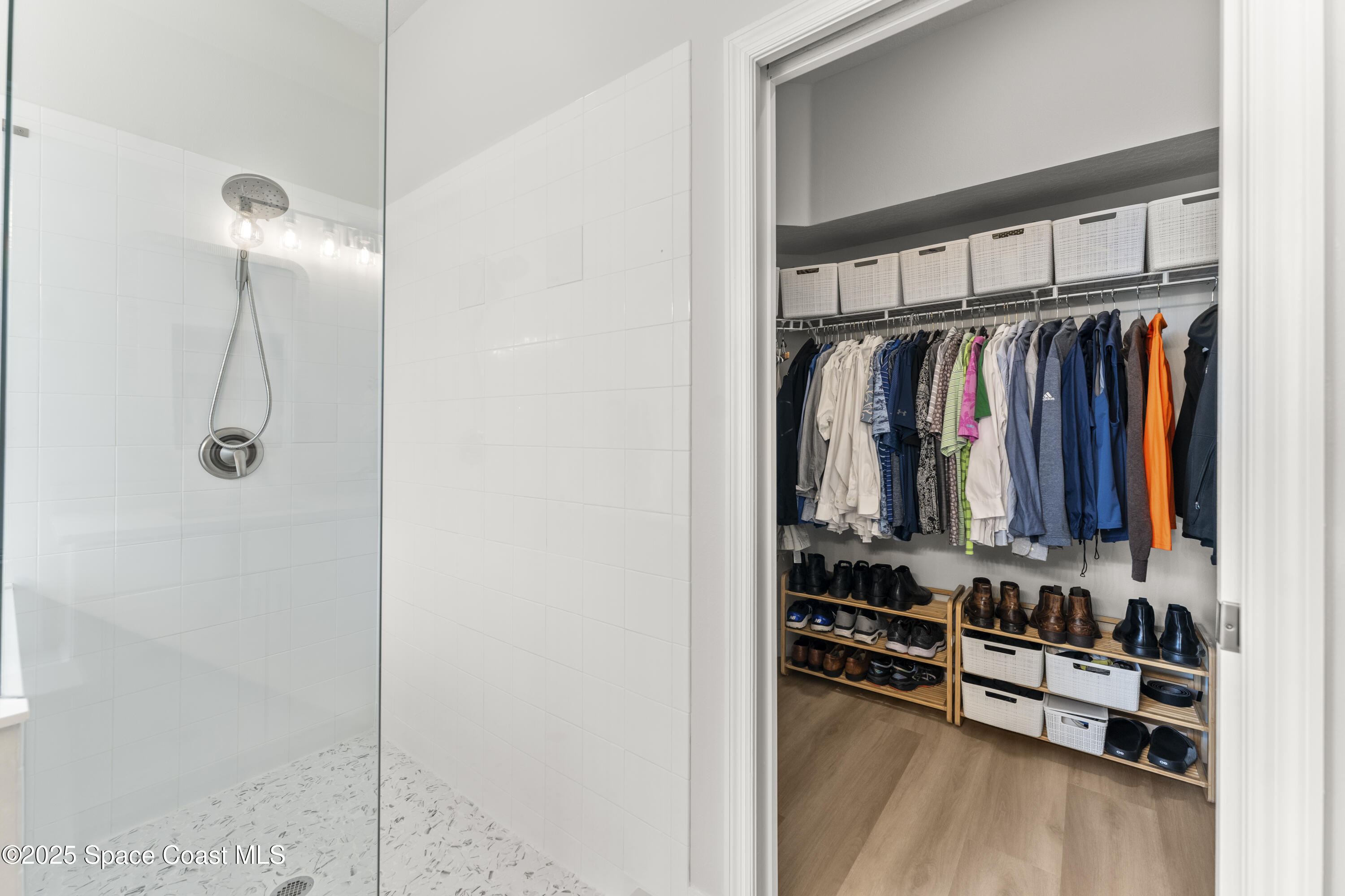 3053 Jacobaeus Lane Indialantic, FL 32903 - Photo 23 of 35 a view of walk in closet with clothes and shoes