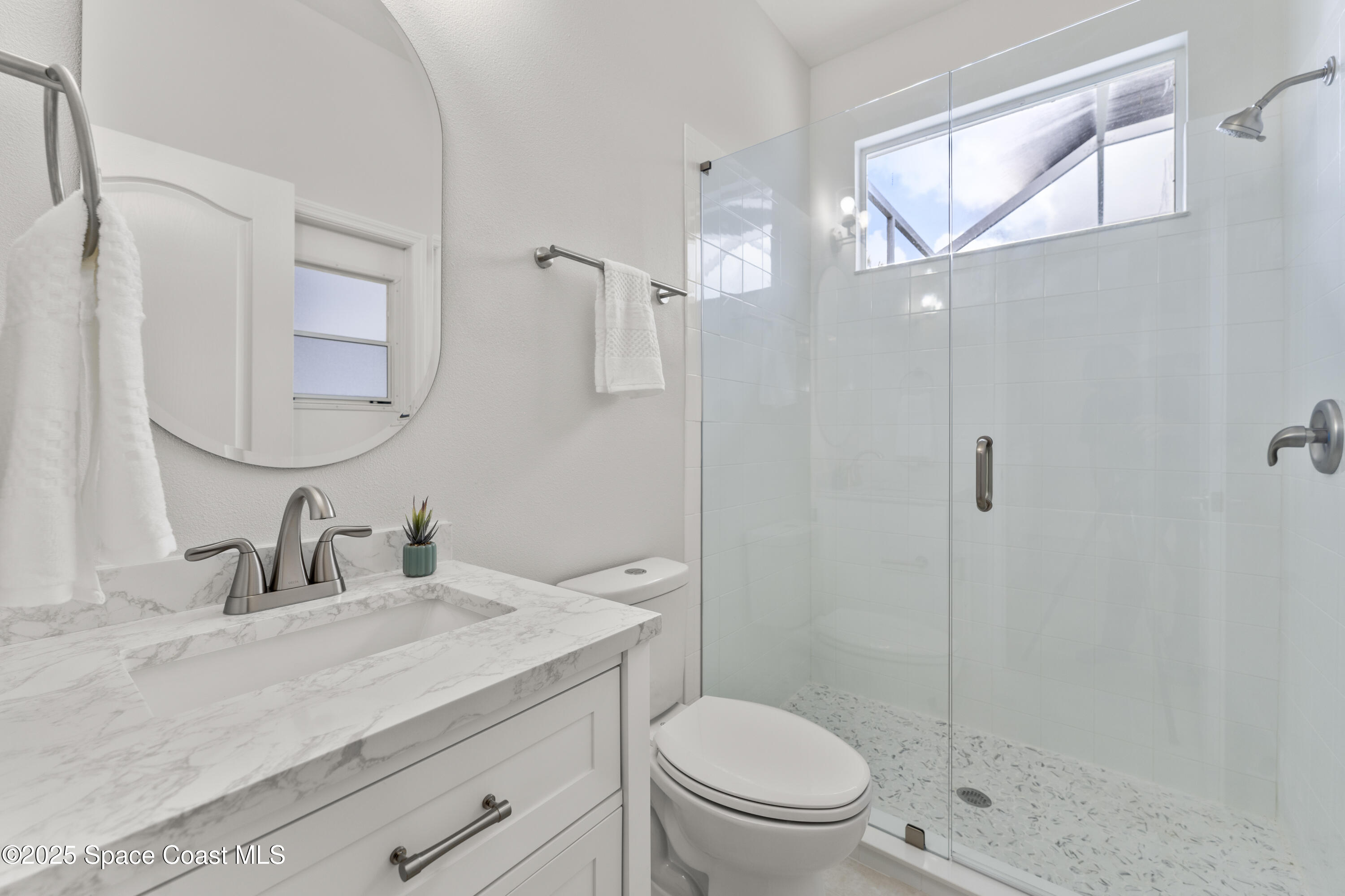 3053 Jacobaeus Lane Indialantic, FL 32903 - Photo 26 of 35 a bathroom with a sink a toilet and shower