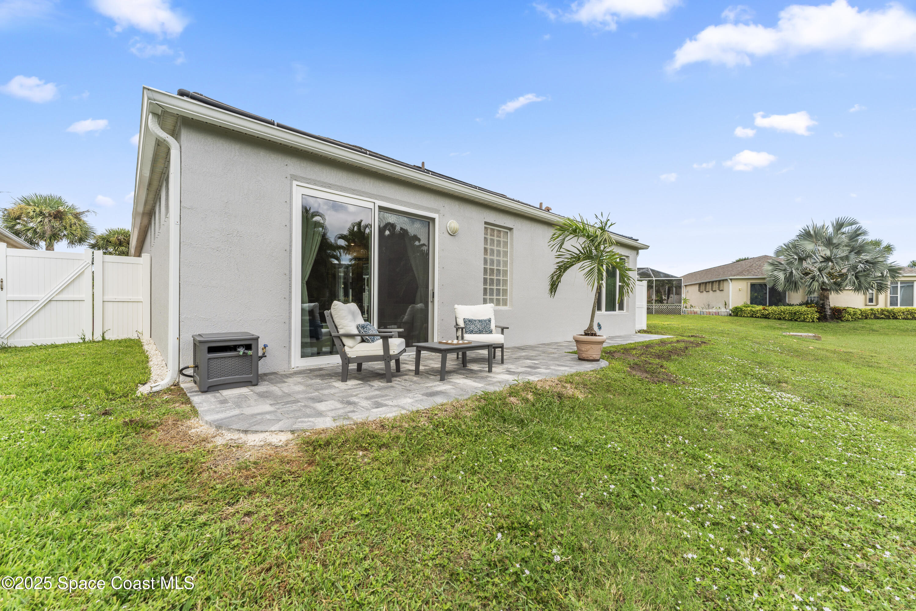 3053 Jacobaeus Lane Indialantic, FL 32903 - Photo 30 of 35 a view of backyard of house with outdoor seating and green space