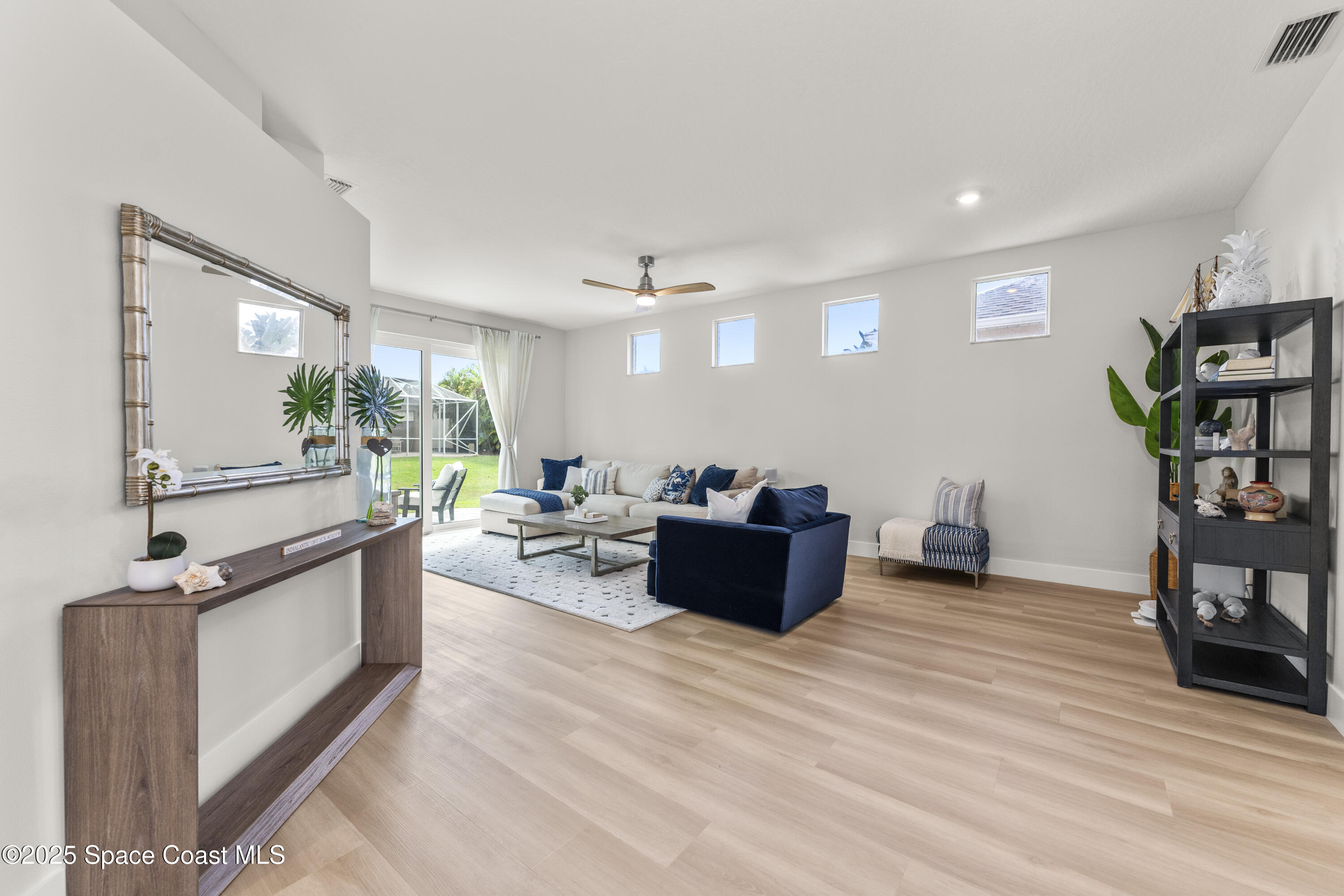 3053 Jacobaeus Lane Indialantic, FL 32903 - Photo 7 of 35 a living room with furniture kitchen view and a wooden floor