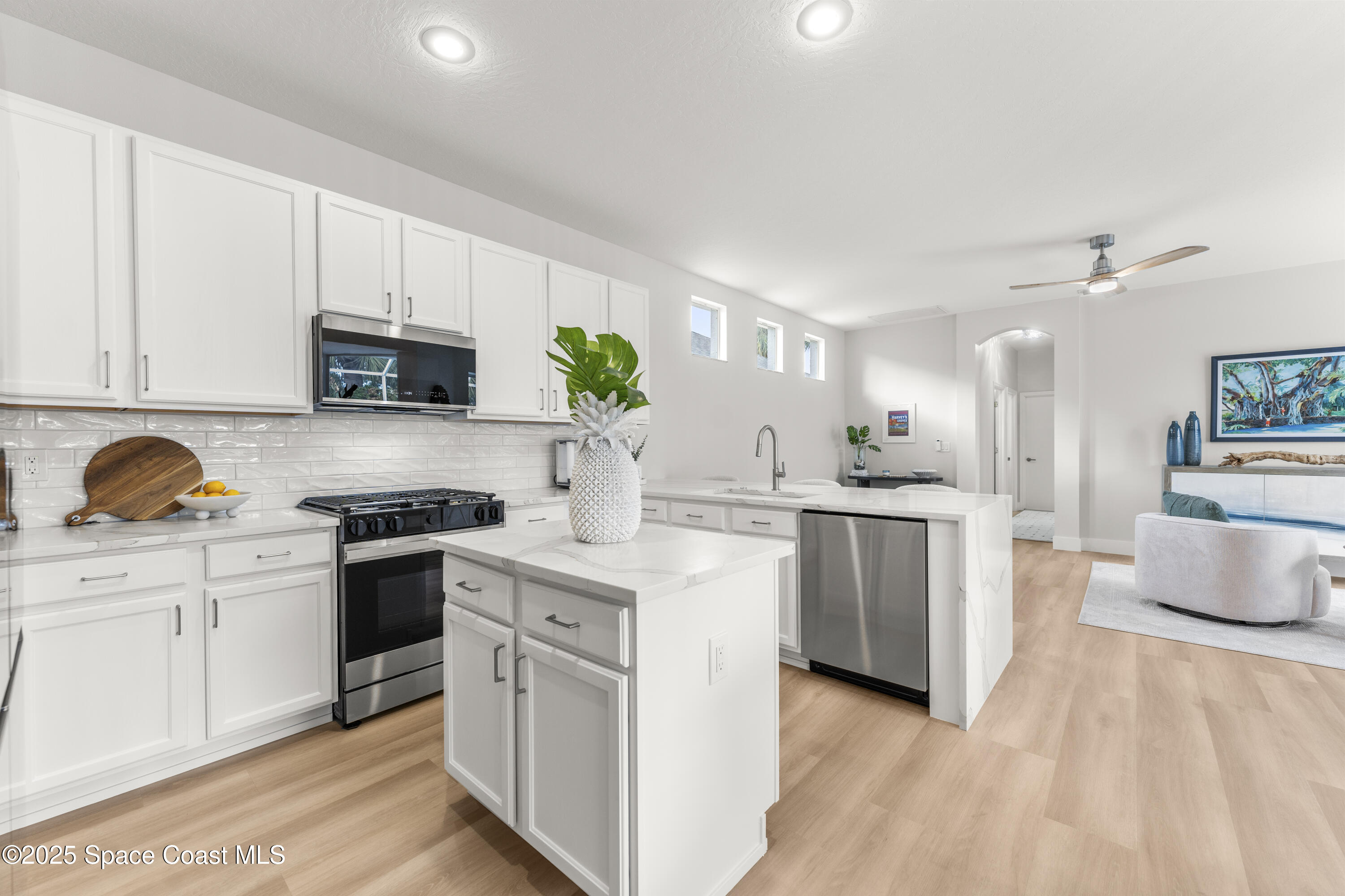 3053 Jacobaeus Lane Indialantic, FL 32903 - Photo 9 of 35 a kitchen with white cabinets and appliances