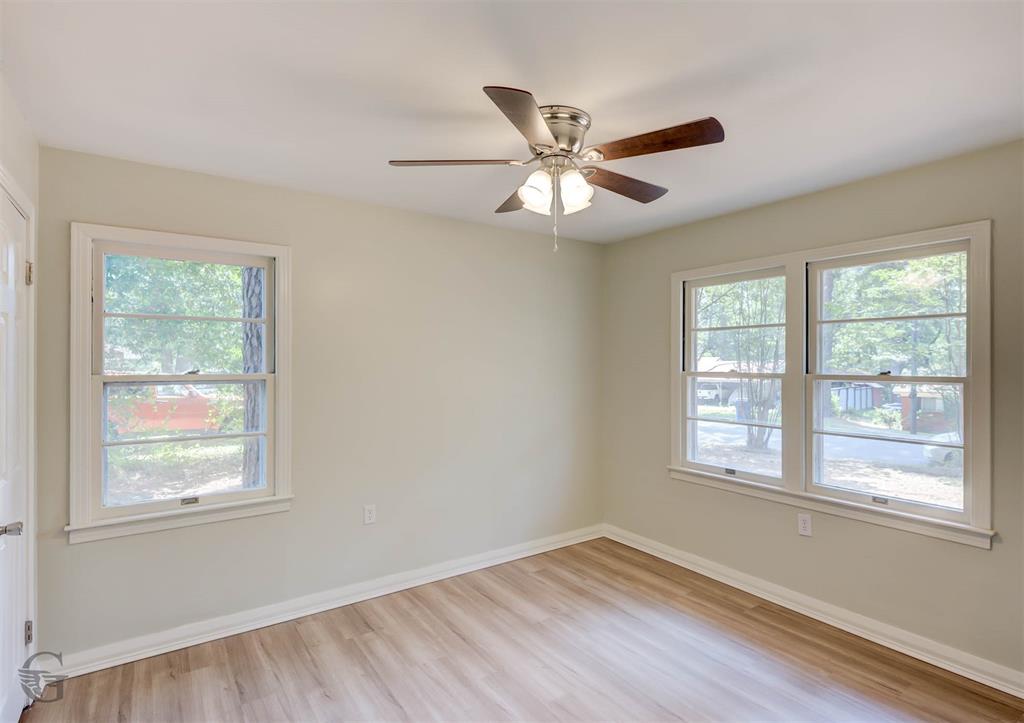 809 Horton Street Minden, LA 71055 - Photo 18 of 20 a view of an empty room with wooden floor and a window
