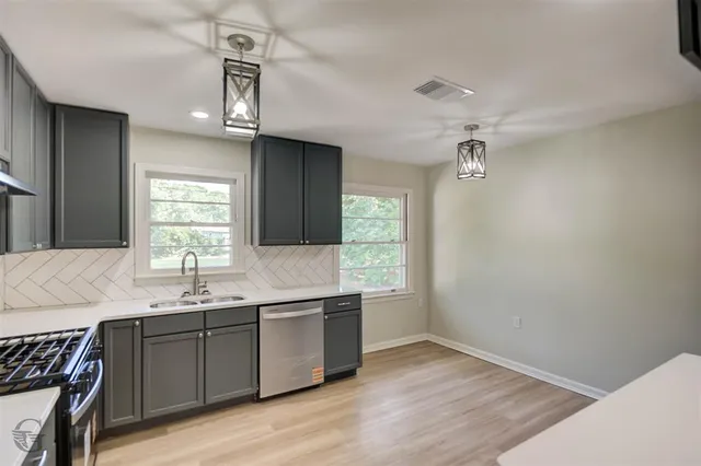 a kitchen with a sink cabinets and window