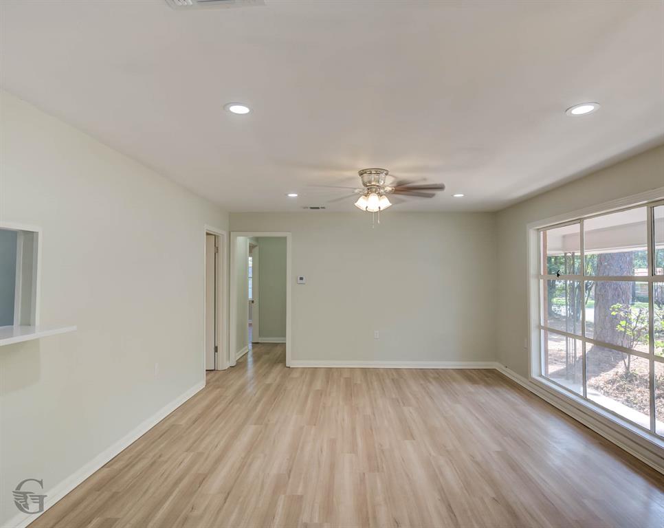 809 Horton Street Minden, LA 71055 - Photo 9 of 20 an empty room with wooden floor and windows