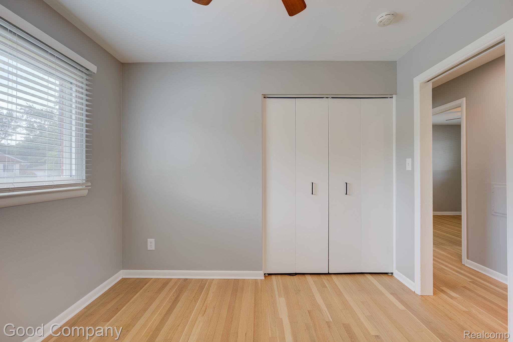 1842 Massoit Road Royal Oak, MI 48073 - Photo 20 of 52 Wood-finish flooring with neutral wall tones, window with horizontal blinds, and bi-fold closet doors