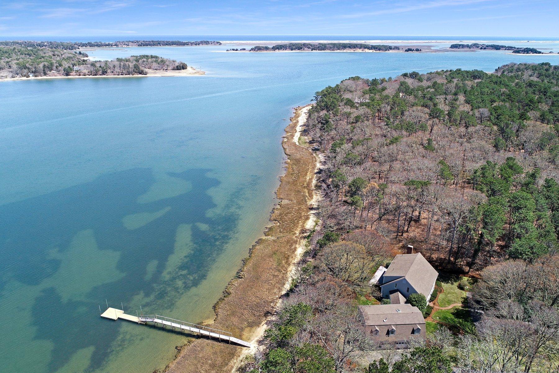 an aerial view of beach and residential houses with outdoor space