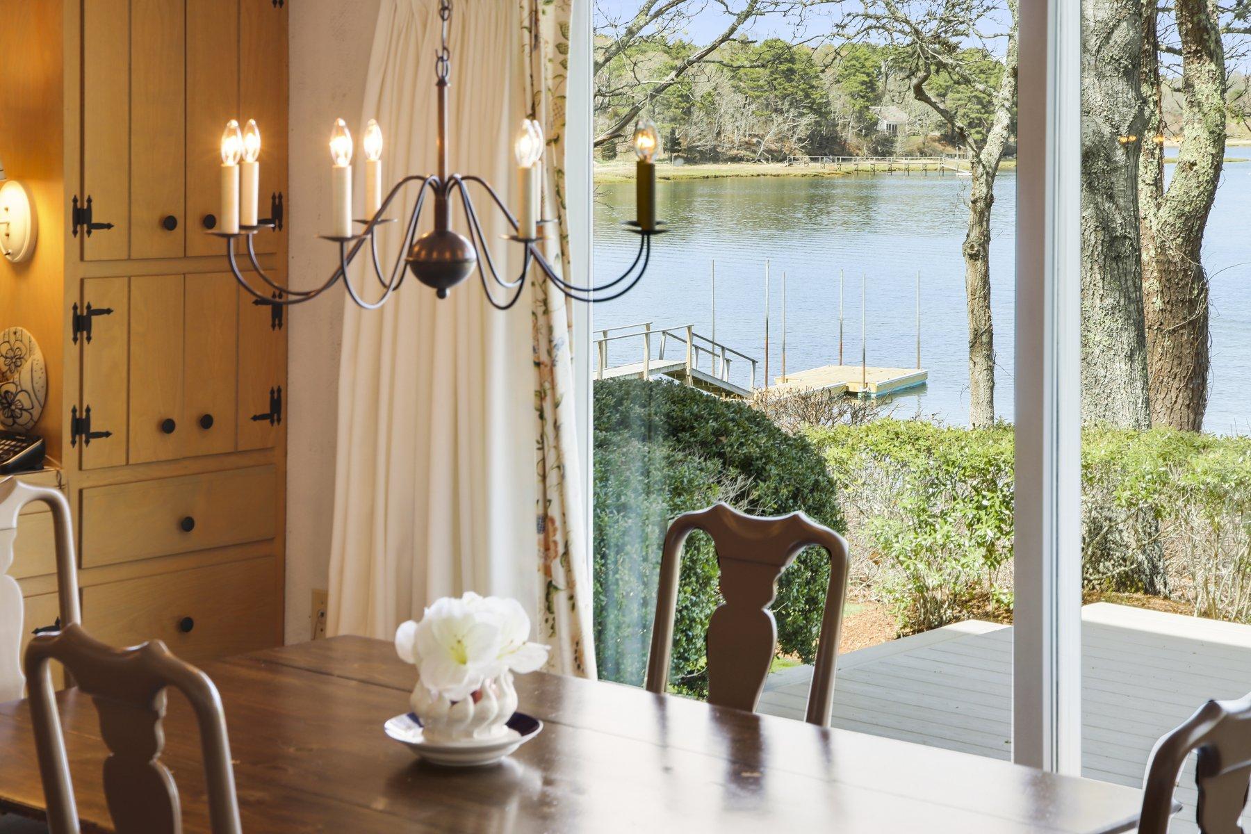 7 Portside Lane Orleans, MA 02653 - Photo 11 of 34 a close view of dining table chairs with chandelier