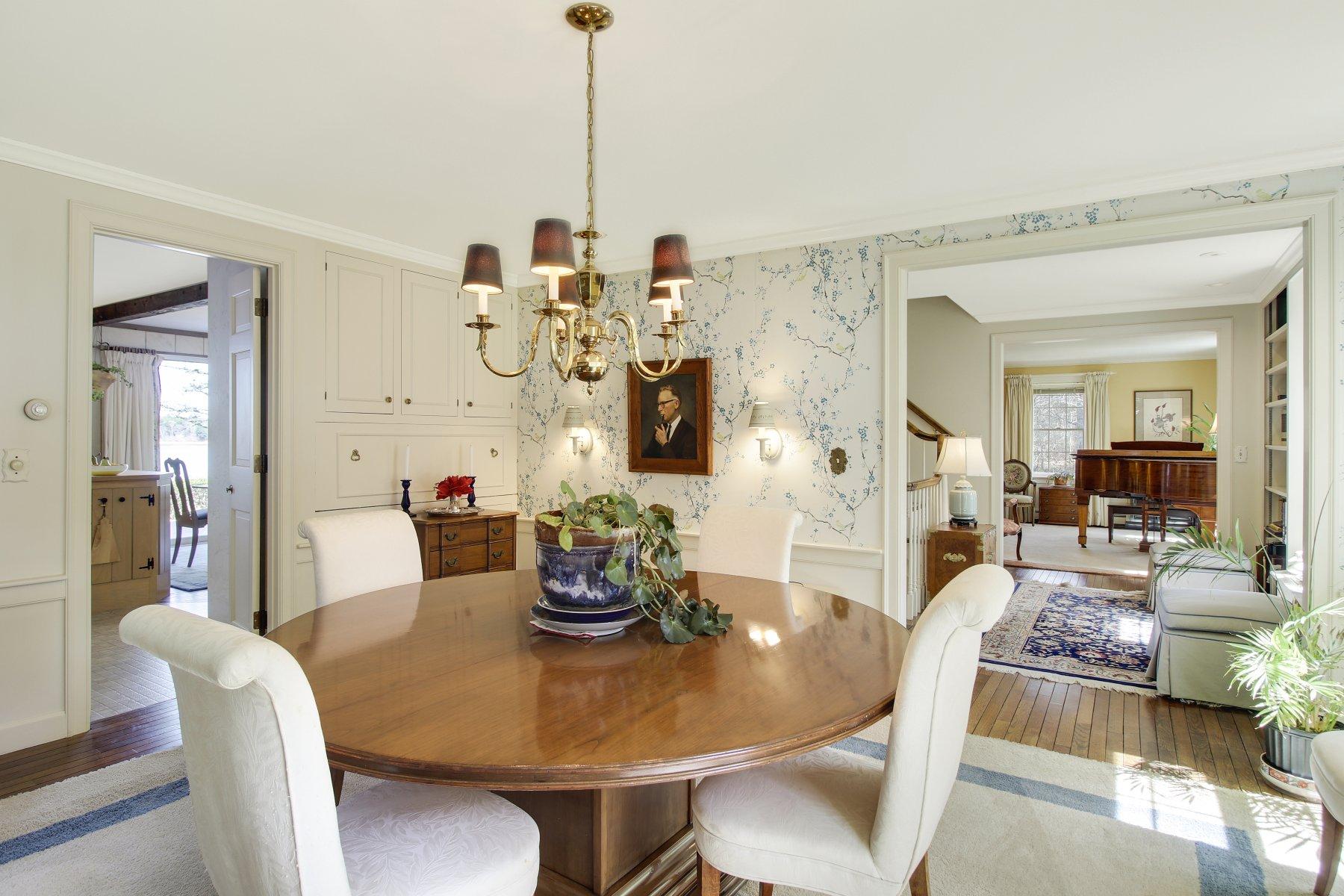 7 Portside Lane Orleans, MA 02653 - Photo 12 of 34 a view of a dining room and livingroom with furniture wooden floor a chandelier
