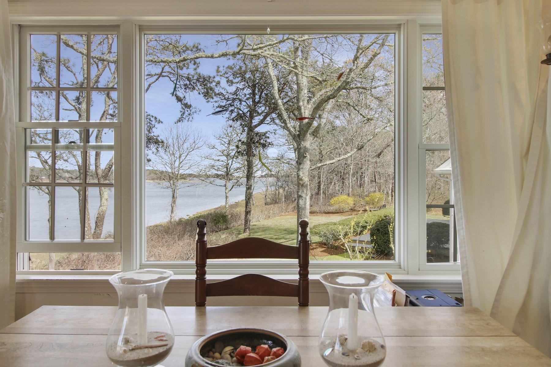 7 Portside Lane Orleans, MA 02653 - Photo 23 of 34 a living room with furniture and a floor to ceiling window