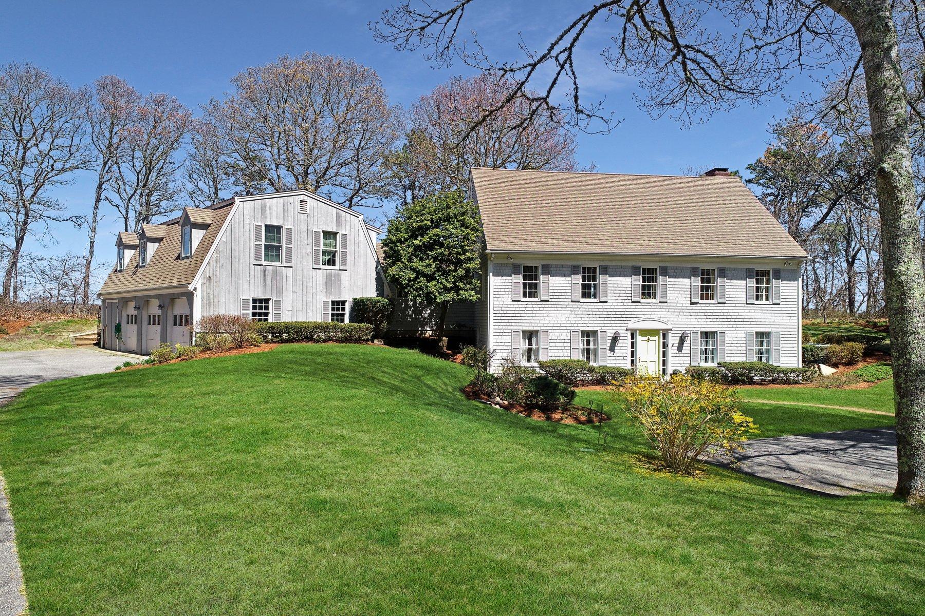 7 Portside Lane Orleans, MA 02653 - Photo 27 of 34 a view of a white house next to a yard with big trees