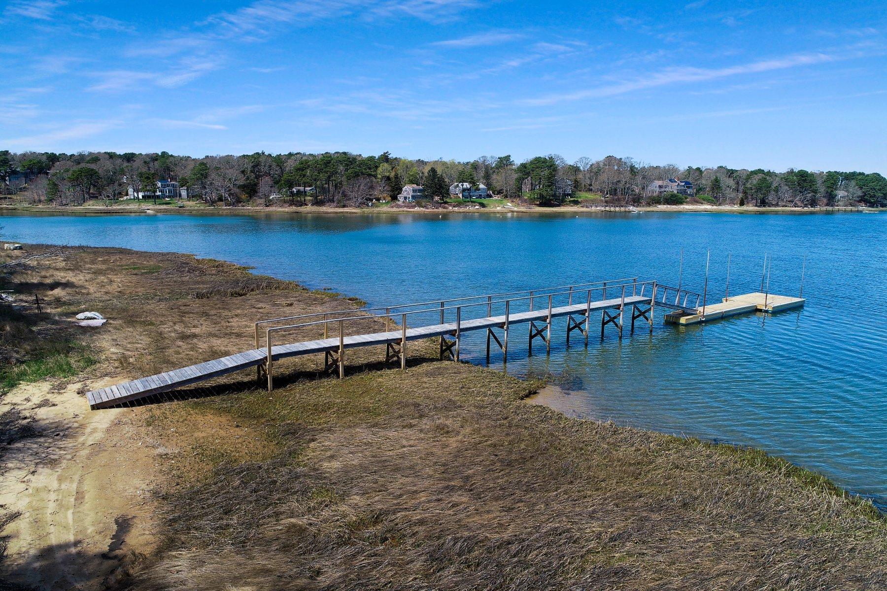 7 Portside Lane Orleans, MA 02653 - Photo 31 of 34 a view of a lake with houses in the back
