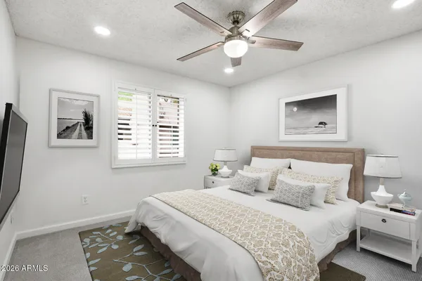 an empty room with a window and a fan