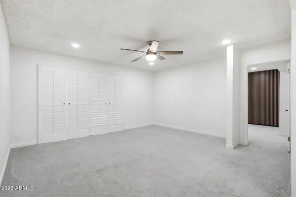 an empty room with fan and a ceiling fan