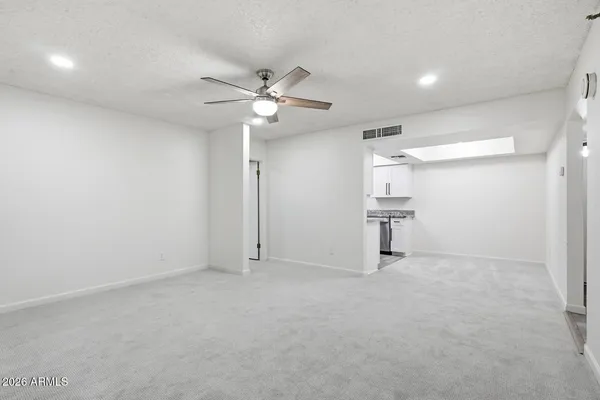 an empty room with closet and windows