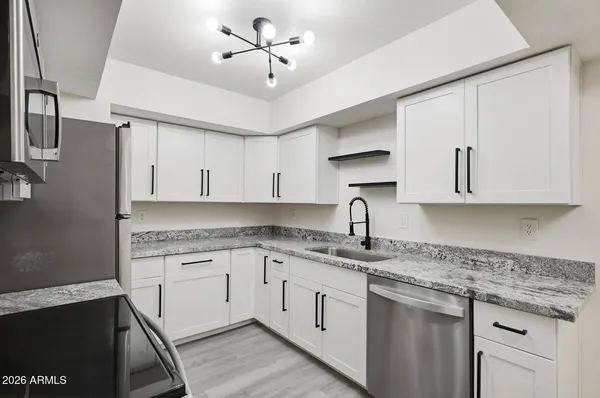 a kitchen with a sink and cabinets