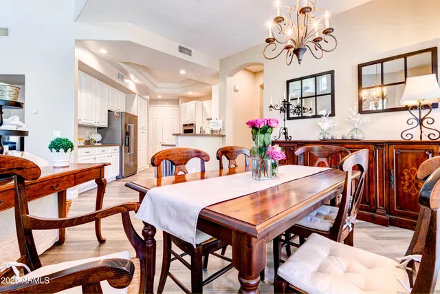 a view of a dining room with furniture and a chandelier