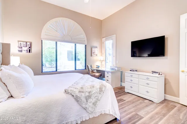 a bedroom with a bed and a flat screen tv